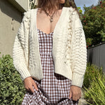 Front portrait of model wearing the Popcorn Stitch Chunky Knit Cardigan in ivory