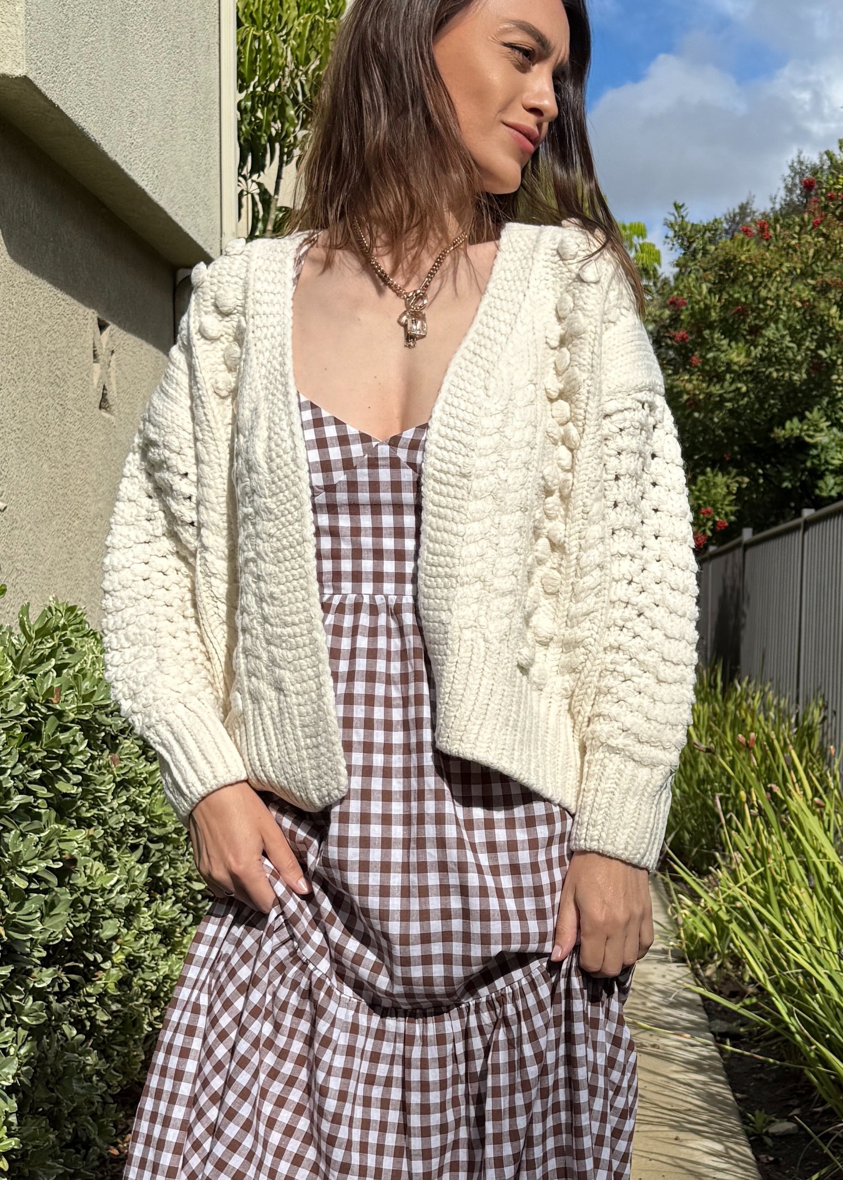 Front portrait of model wearing the Popcorn Stitch Chunky Knit Cardigan in ivory