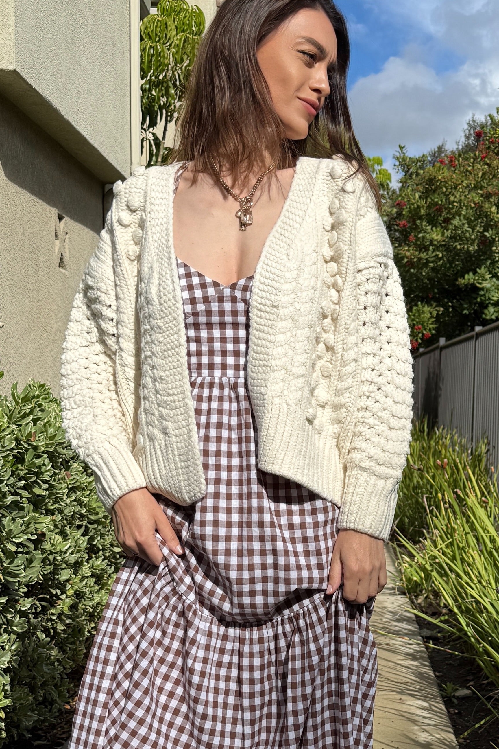 Front portrait of model wearing the Popcorn Stitch Chunky Knit Cardigan in ivory