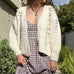 Front portrait of model wearing the Popcorn Stitch Chunky Knit Cardigan in ivory
