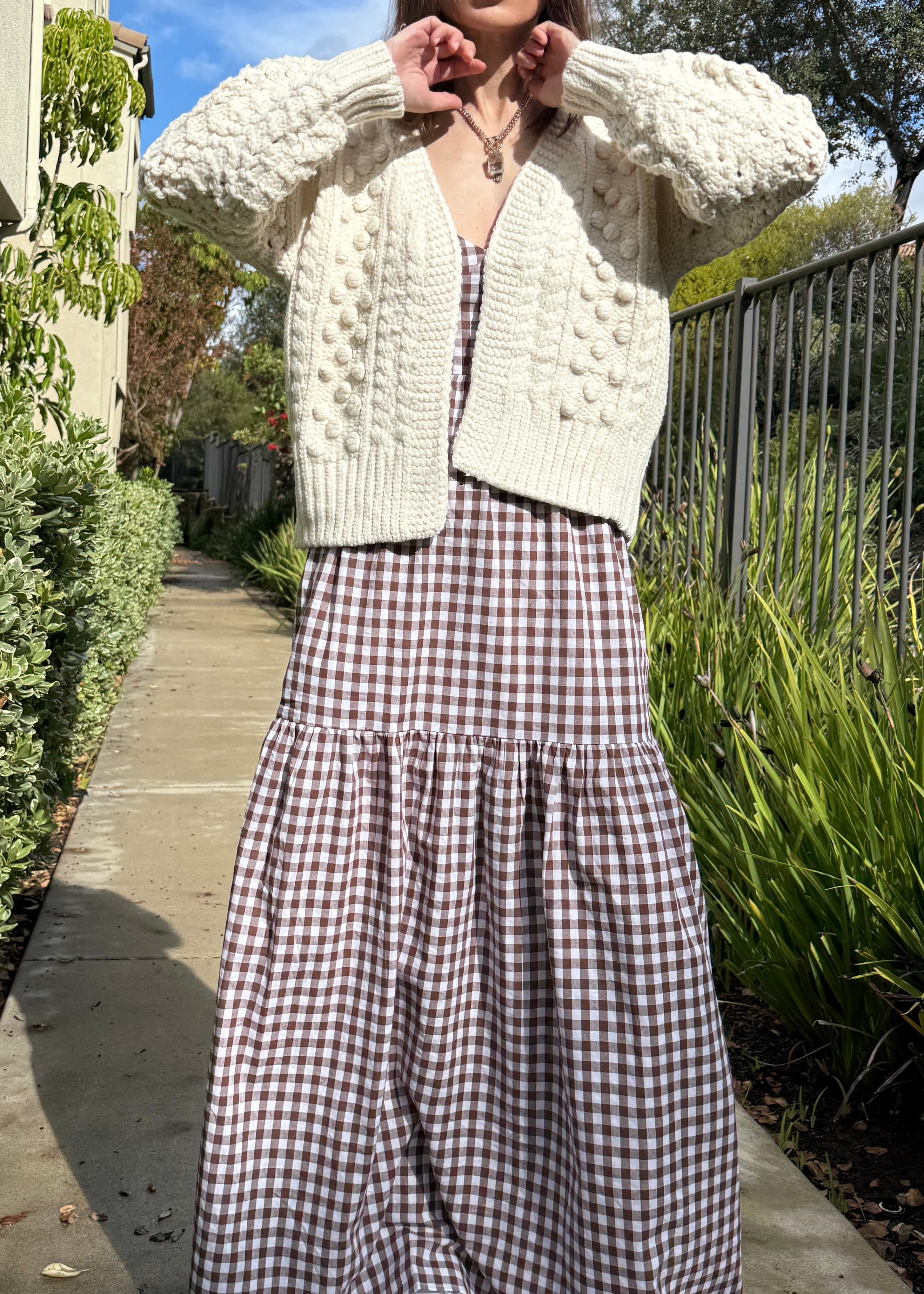 Full-body view of the Popcorn Stitch Chunky Knit Cardigan in ivory styled casually outdoors