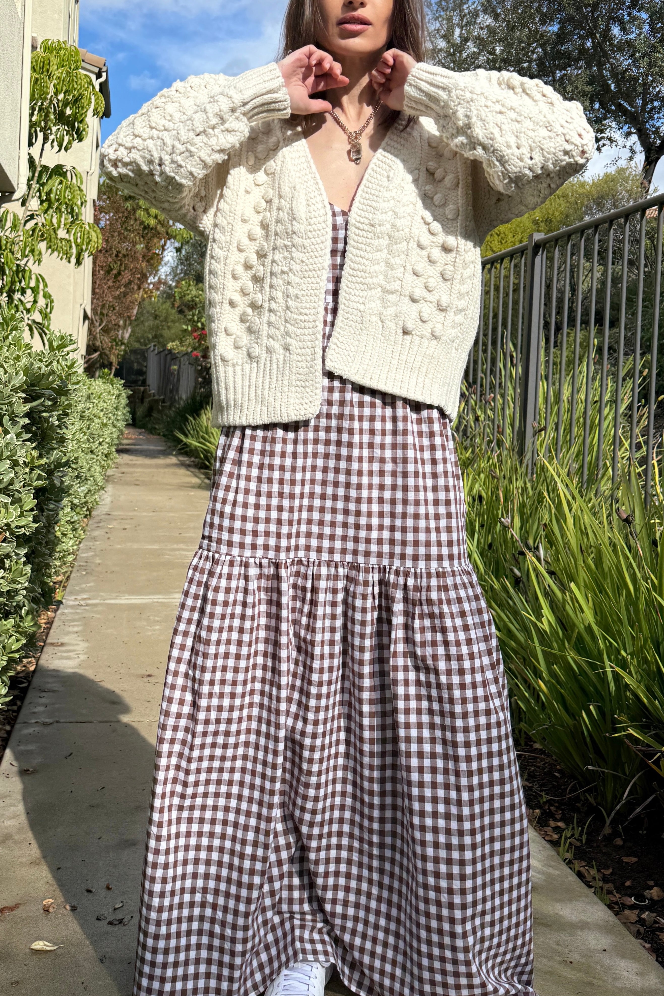 Full-body view of the Popcorn Stitch Chunky Knit Cardigan in ivory styled casually outdoors