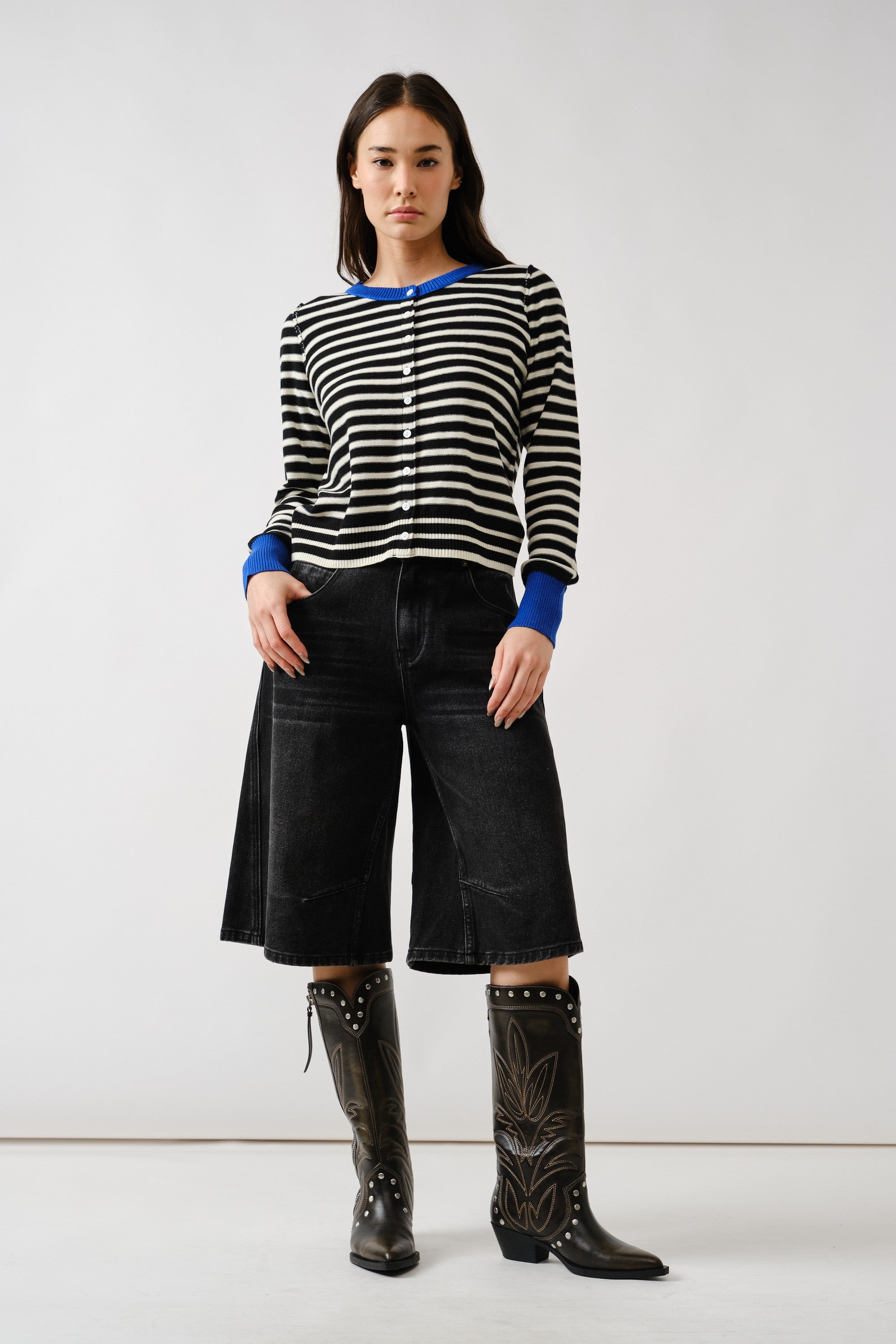 Full body view of Porta striped button down cardigan sweater styled with black pants