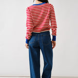 Person wearing a red and white striped sweater and blue jeans on a white background