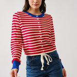 Woman wearing a red and white striped shirt with blue accents on a plain background