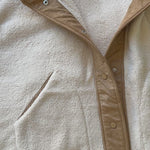 Unboxing video of the Sienna Knit Collar Puffer Jacket in brown, showing packaging, knit collar detail, quilted texture, and overall finish