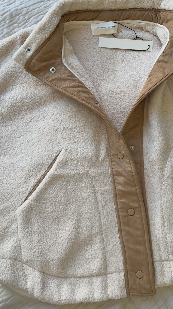 Unboxing video of the Sienna Knit Collar Puffer Jacket in brown, showing packaging, knit collar detail, quilted texture, and overall finish