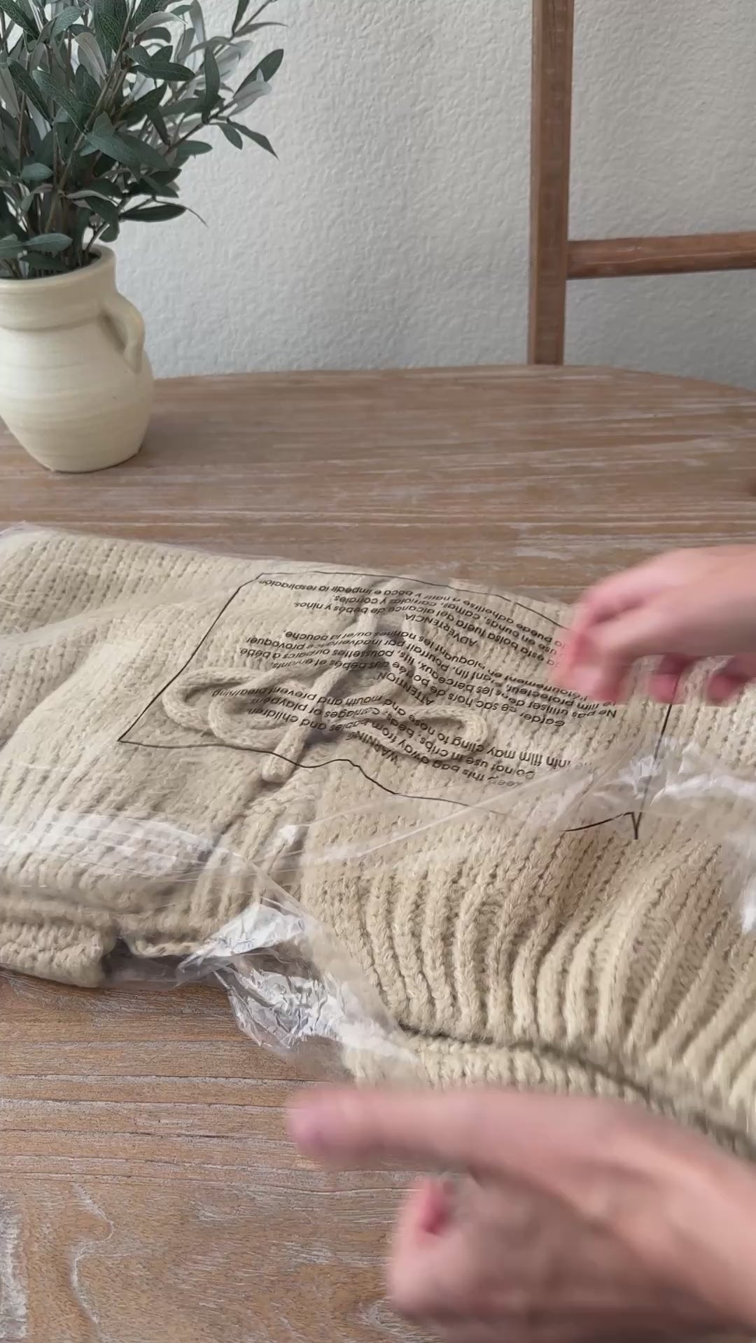 Unpackaging  the Willow Boho Tie Cardigan, also known as the Sadie Tie Front Cardigan, in red — cozy bohemian knit with tie-front closure and relaxed oversized fit.