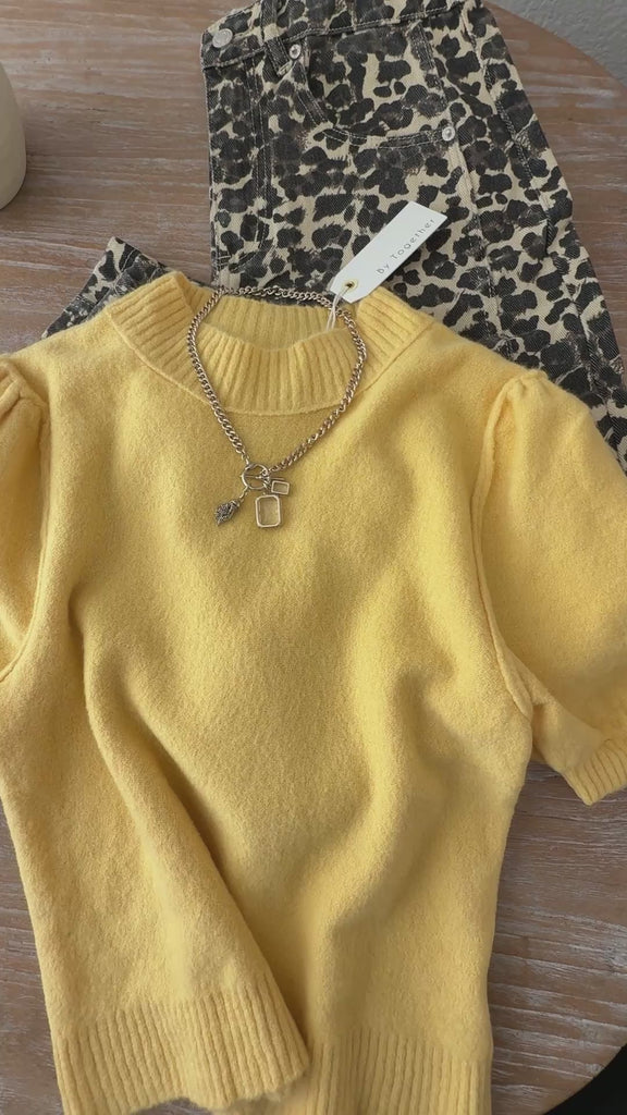 Flat lay overview video of the Soft Balloon Sleeve Short Sleeve Sweater in yellow, showing knit texture, balloon sleeves, and crew neckline