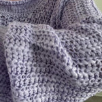 Try-on video of SoftSpun textured boatneck sweater in lavender showing relaxed fit and off-shoulder styling