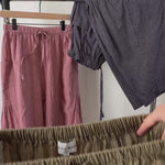 Close-up video of elastic waistband and green pinstripe cotton texture on Quinn pants