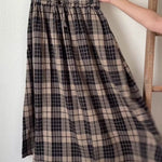 video of details of Ives plaid A-line maxi skirt in black and stone