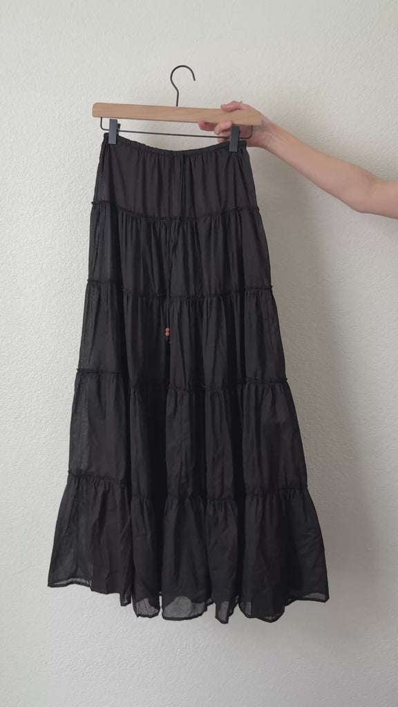 Video of the One Brynn black cotton tiered maxi skirt showing movement and fabric texture