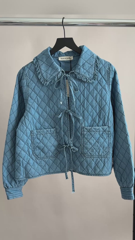 Close-up video of Chloe Bow Quilted Denim Jacket showing quilted texture and bow tie closures