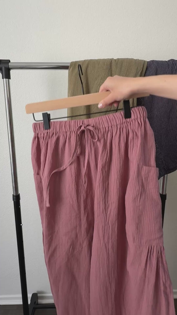 Close-up video of elastic waistband, drawstring, and pinstripe texture on Quinn cotton pants