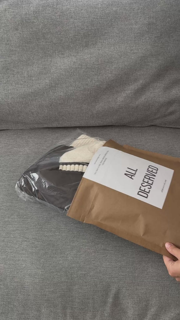 Unboxing video of the Sienna Knit Collar Puffer Jacket in brown, showing packaging, knit collar detail, quilted texture, and overall finish