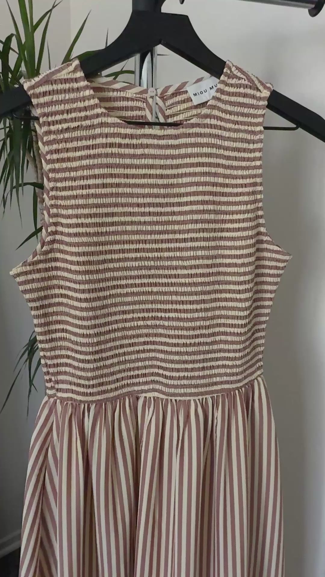 Close-up video of smocked bodice and striped fabric on Darcy maxi dress