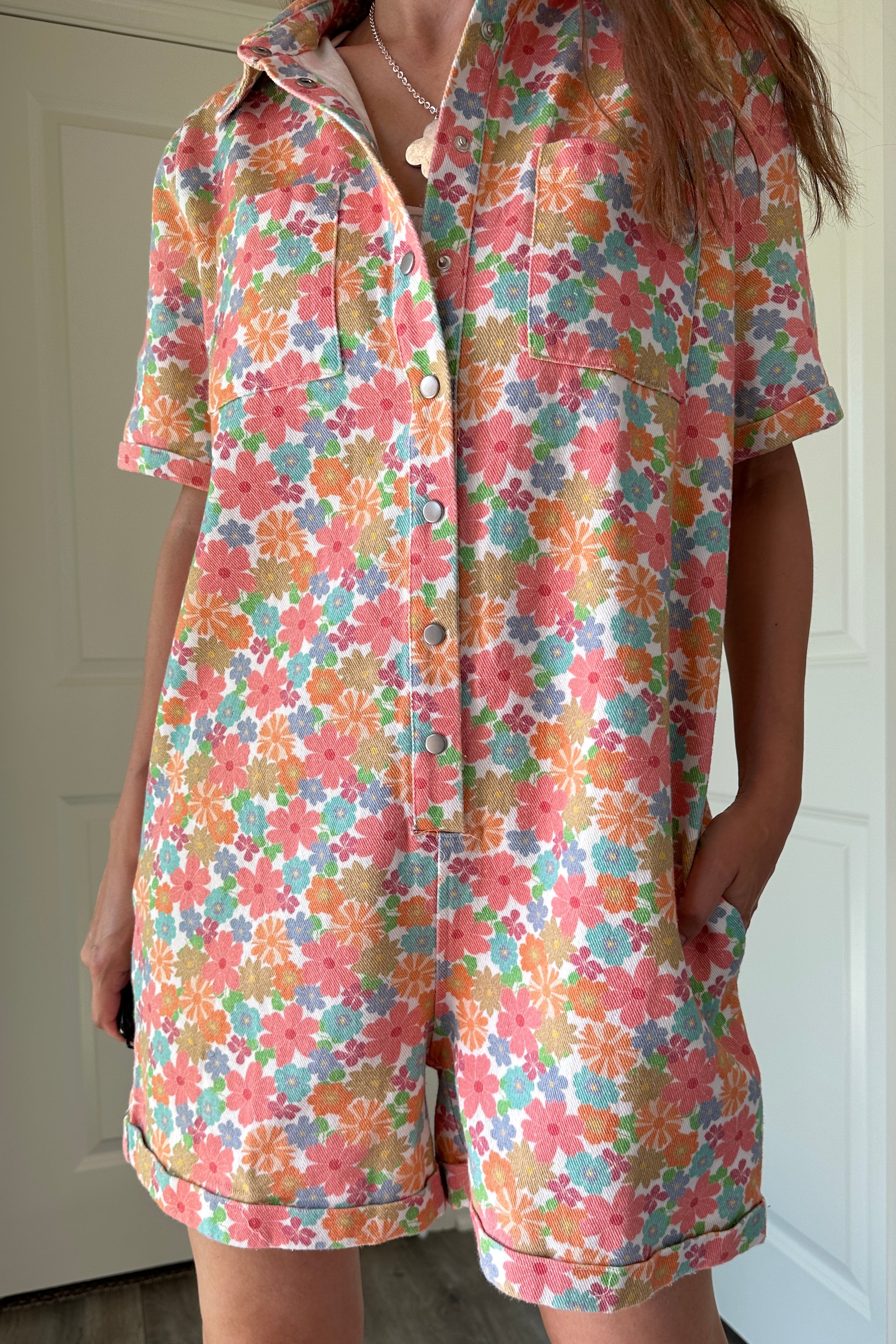 try-on video of Chloe Floral Denim Utility Romper 
