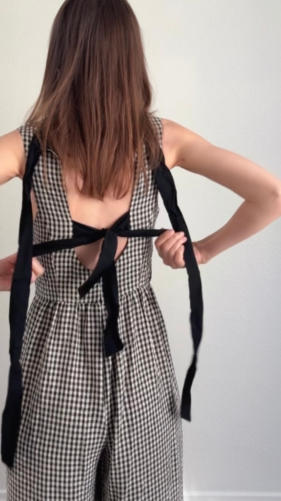 Model wearing Mila Gingham Bow Back Wide Leg Jumpsuit in Black try-on video