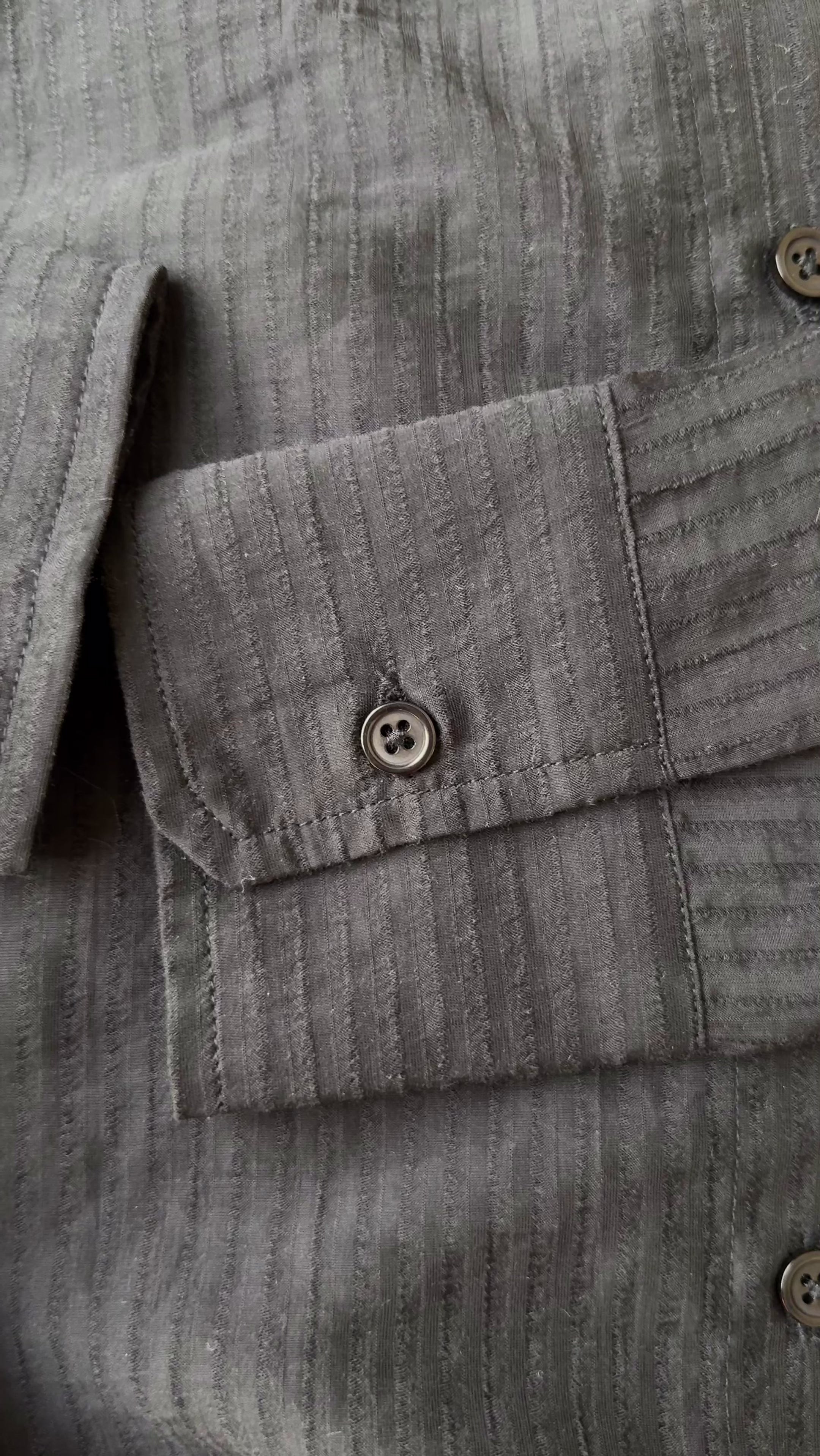 video Close-up of the semi-sheer pinstripe fabric and button