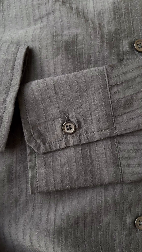 video Close-up of the semi-sheer pinstripe fabric and button