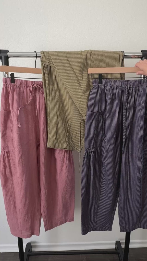 Close-up video of elastic waistband, drawstring, and blue pinstripe cotton texture on Quinn pants