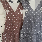 Close-up details of Aaron & Amber black polka dot barrel-leg denim overalls with adjustable straps, pockets, and 100% cotton denim
