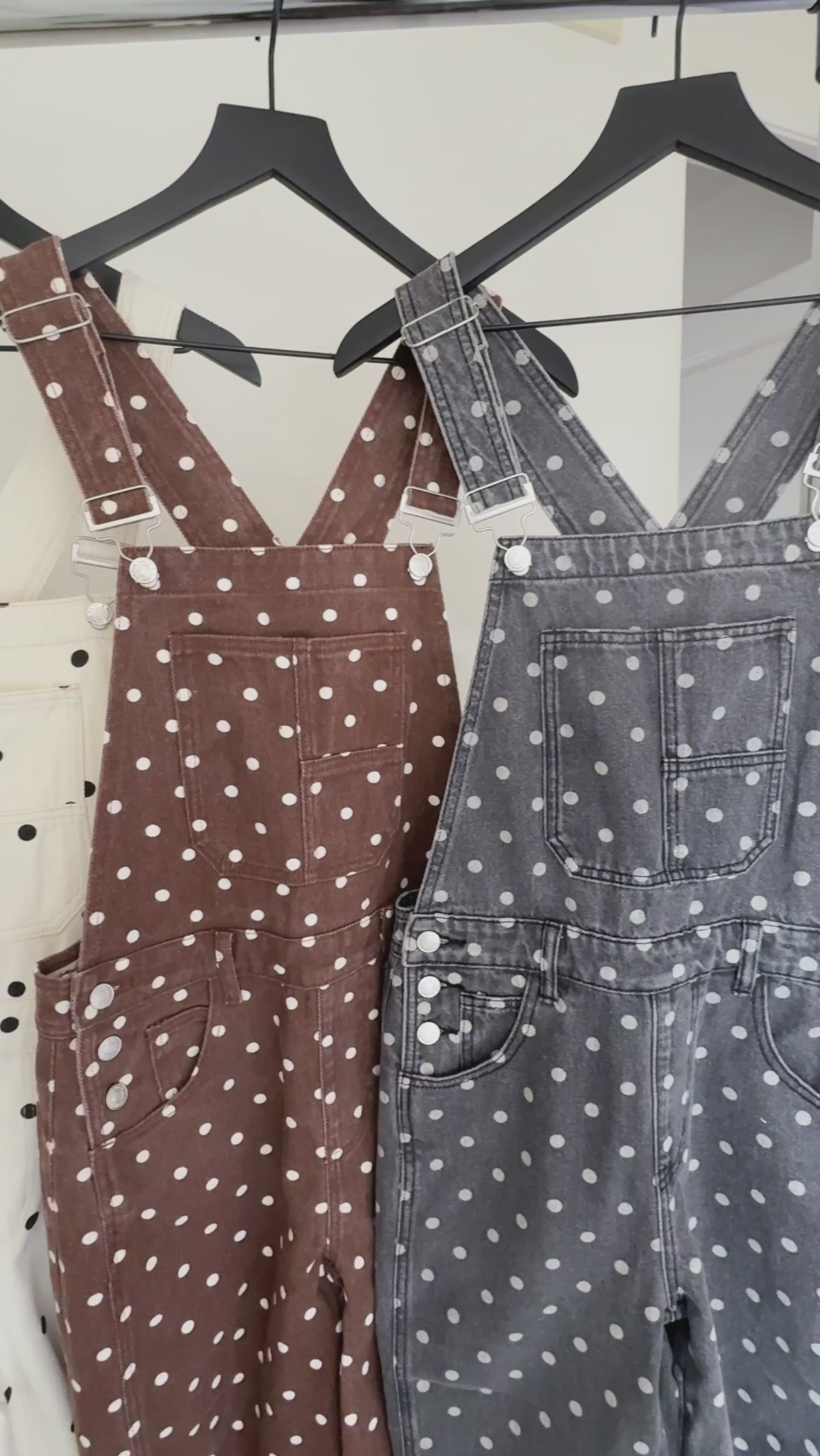 Close-up details of Aaron & Amber black polka dot barrel-leg denim overalls with adjustable straps, pockets, and 100% cotton denim