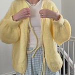 try-on video - woman is wearing yellow bow tie  cardigan