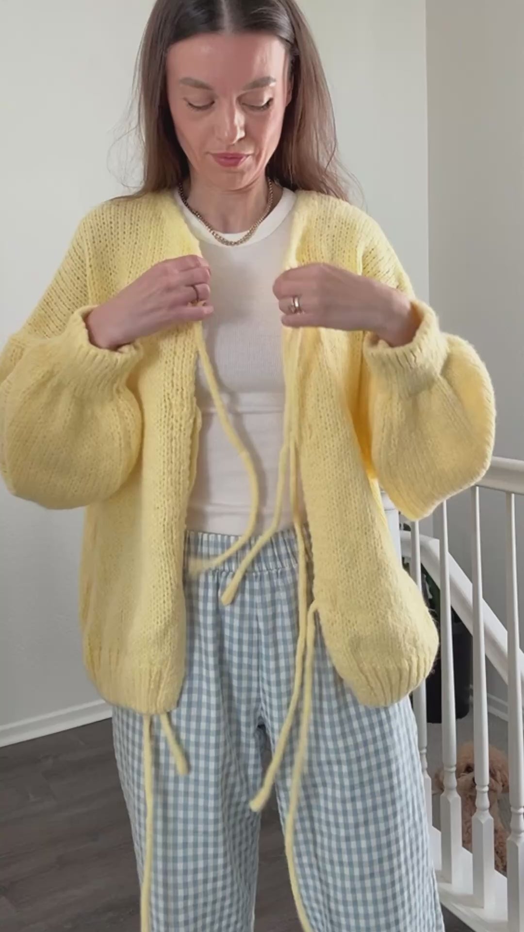 try-on video - woman is wearing yellow bow tie  cardigan
