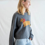 Angled front view of Puppy Love crew sweater in charcoal