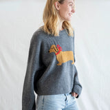 Angled front view of Puppy Love crew sweater in charcoal