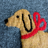 Close-up of dog print with red bow on Puppy Love sweater