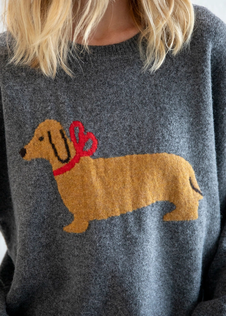 Close-up of dog illustration with red bow on Puppy Love sweater