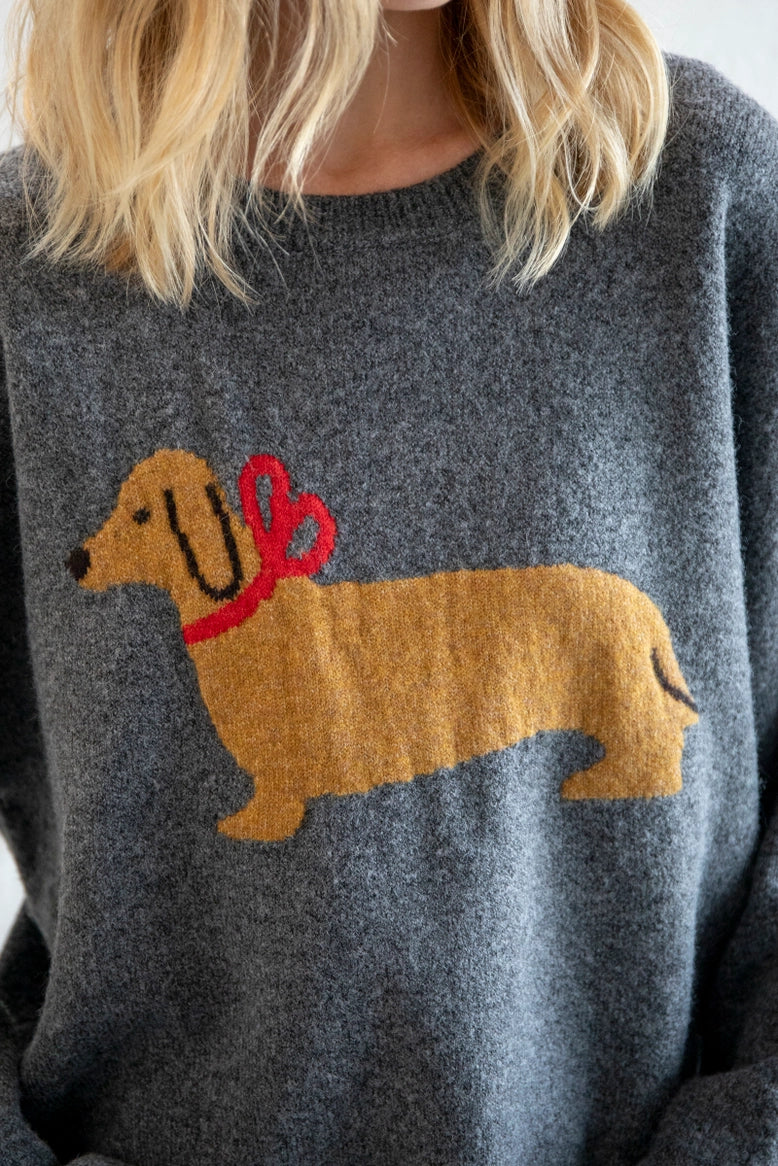 Close-up of dog illustration with red bow on Puppy Love sweater