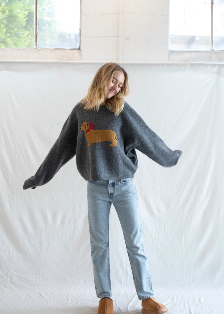 Woman wearing Puppy Love crew sweater in charcoal styled casually - lifestyle front view