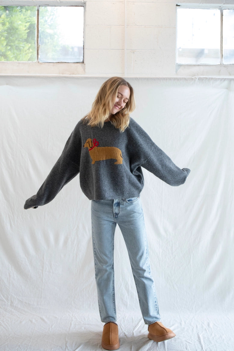Woman wearing Puppy Love crew sweater in charcoal styled casually - lifestyle front view