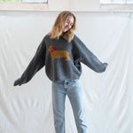 Woman wearing Puppy Love crew sweater in charcoal styled casually - lifestyle front view