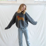 Woman wearing Puppy Love crew sweater in charcoal styled casually - lifestyle front view