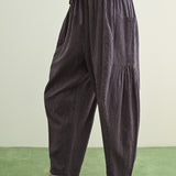 Side view of Quinn blue and stone pinstripe cotton pants with billowy harem silhouette