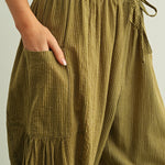 Elastic waistband and drawstring detail on Quinn green pinstripe cotton pants