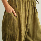 Elastic waistband and drawstring detail on Quinn green pinstripe cotton pants
