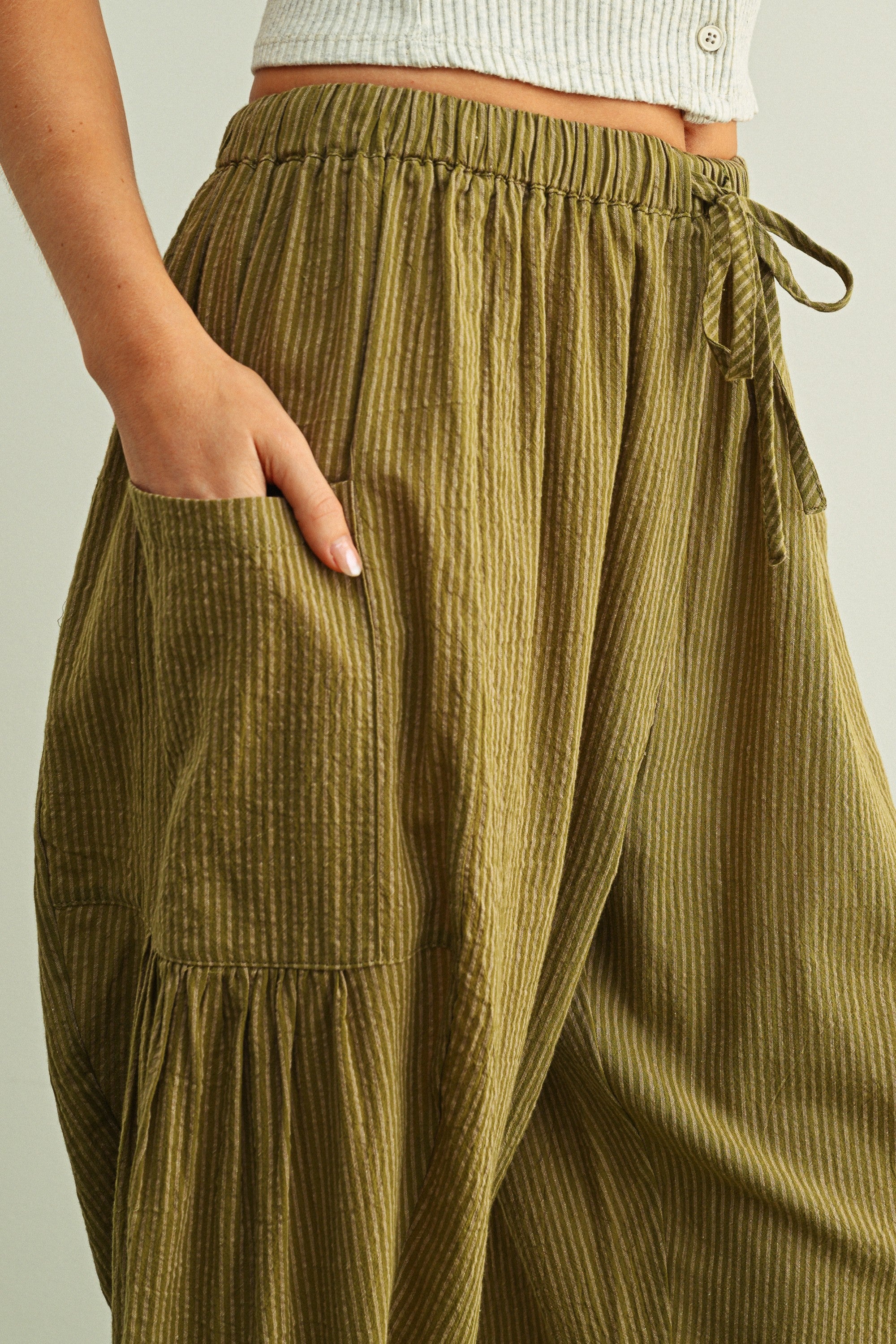 Elastic waistband and drawstring detail on Quinn green pinstripe cotton pants