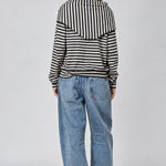 Back studio view of the Remi striped sweatshirt showing its relaxed fit and matching black and cream hip scarf