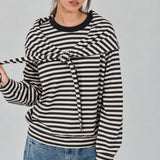 Front studio view of the Remi black and cream striped cotton sweatshirt with matching triangle scarf tied around the hips