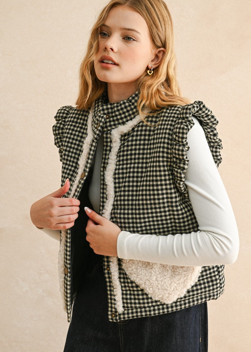 Close-up front view of the black gingham vest showing button-down front, stand collar, and ruffled shoulders