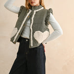 Three-quarter front view of the Rosie gingham puffer vest in black, layered over a long sleeve top