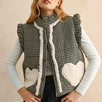 Model wearing the Rosie Gingham Sherpa Puffer Vest in black, front portrait view with sherpa heart pockets