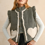Model wearing the Rosie Gingham Sherpa Puffer Vest in black, front portrait view with sherpa heart pockets