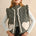 Model wearing the Rosie Gingham Sherpa Puffer Vest in black, front portrait view with sherpa heart pockets